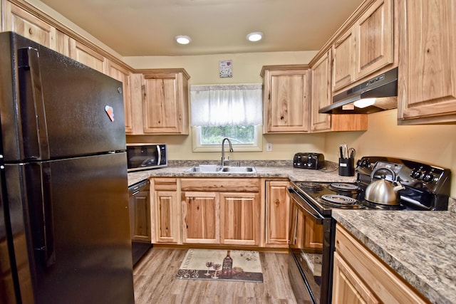 594 Sullivan Trl, Long Pond, PA 18334 - kitchen with black appliances, under cabinet range hood, and light brown cabinetry