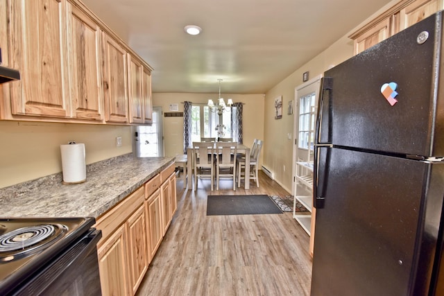 594 Sullivan Trl, Long Pond, PA 18334 - kitchen with black appliances, light brown cabinetry, and a chandelier