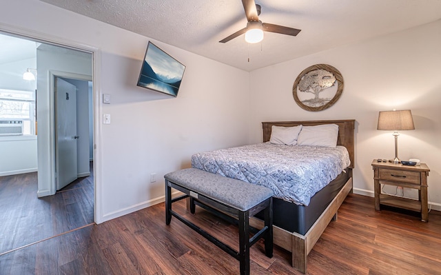 bedroom featuring ceiling fan, a textured ceiling, wood finished floors, cooling unit, and baseboards