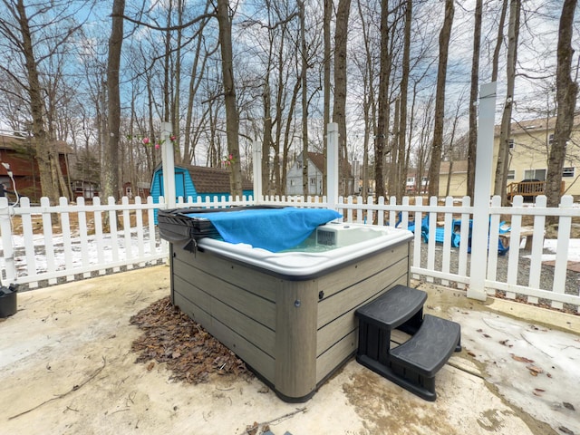 view of patio / terrace with fence and a hot tub