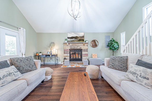 living room featuring high vaulted ceiling, a stone fireplace, stairway, and wood finished floors