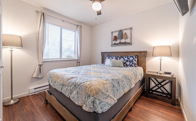 bedroom with a ceiling fan, a baseboard radiator, baseboards, and wood finished floors