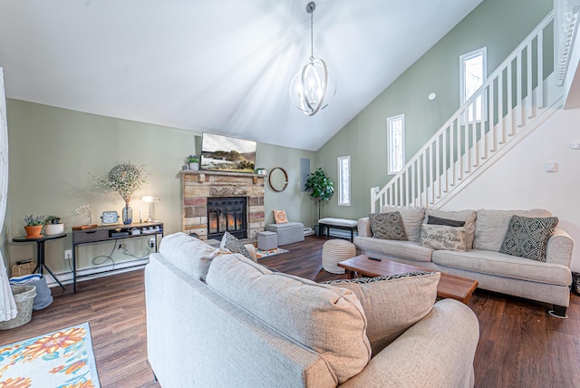 living area with a baseboard radiator, a fireplace, stairs, dark wood-style floors, and an inviting chandelier