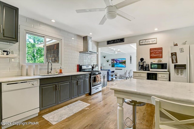 188 Olde Schoolhouse Rd, Cresco, PA 18326 - kitchen featuring light wood-type flooring, a ceiling fan, a sink, white appliances, and wall chimney exhaust hood