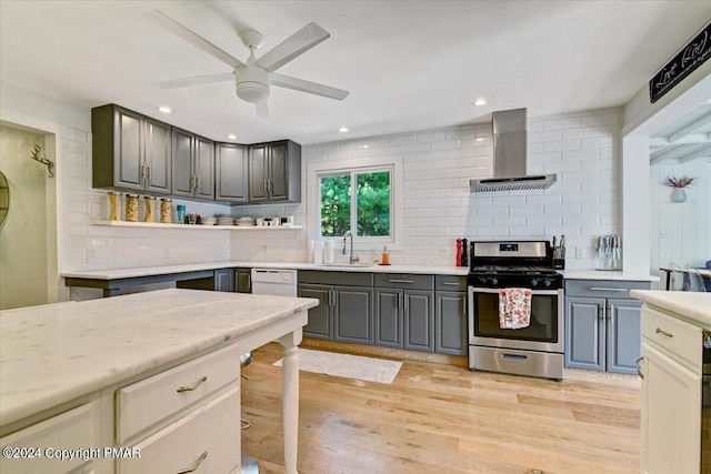 188 Olde Schoolhouse Rd, Cresco, PA 18326 - kitchen featuring gray cabinets, a sink, wall chimney exhaust hood, light wood finished floors, and stainless steel range with gas stovetop