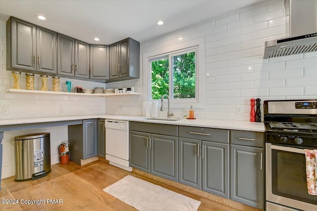188 Olde Schoolhouse Rd, Cresco, PA 18326 - kitchen with stainless steel gas stove, gray cabinetry, a sink, light wood-style floors, and white dishwasher
