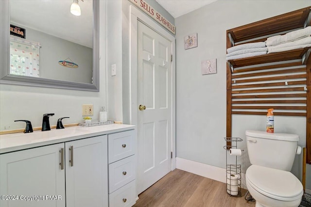 188 Olde Schoolhouse Rd, Cresco, PA 18326 - bathroom with baseboards, toilet, wood finished floors, and vanity