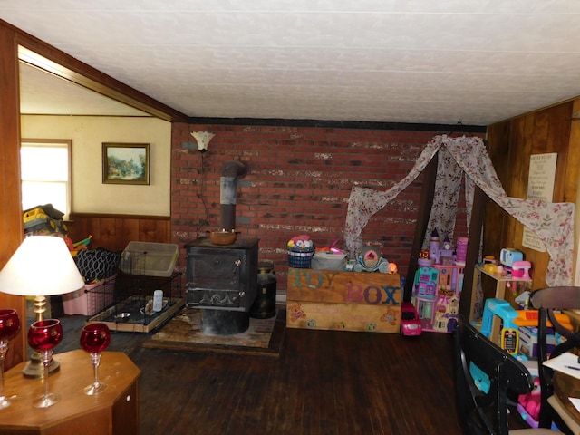 1212 Lower Cherry Valley Rd, Stroudsburg, PA 18360 - living room featuring wooden walls, wood finished floors, a wood stove, and a wainscoted wall