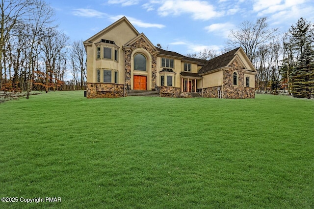 view of front of home with stone siding, a front lawn, and stucco siding