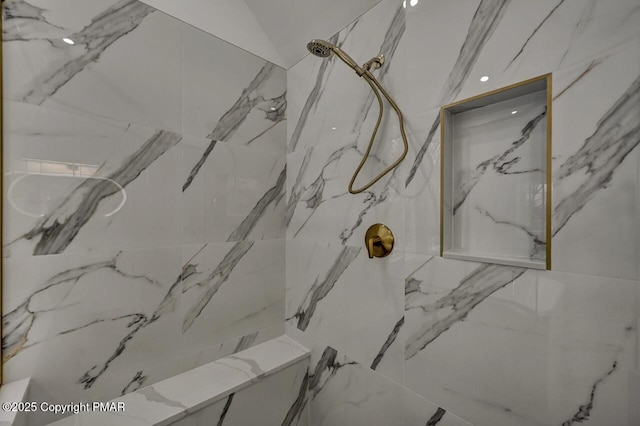 details featuring a marble finish shower