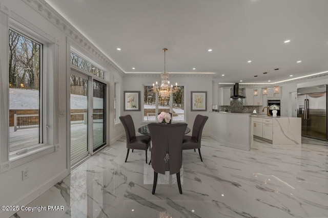 dining space featuring ornamental molding, recessed lighting, baseboards, and an inviting chandelier