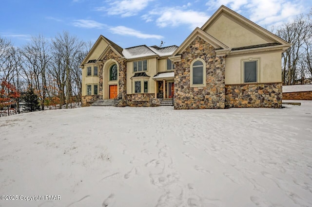 view of front facade featuring stone siding and stucco siding