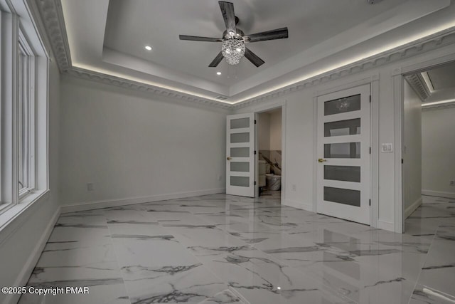 empty room with baseboards, ceiling fan, marble finish floor, a tray ceiling, and recessed lighting