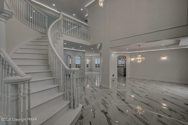 707 Kennedy Ct, East Stroudsburg, PA 18301 - stairway with a chandelier, marble tiled flooring, a towering ceiling, baseboards, and recessed lighting