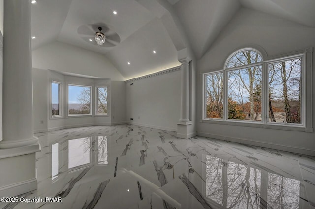 empty room with a ceiling fan, marble finish floor, baseboards, and ornate columns