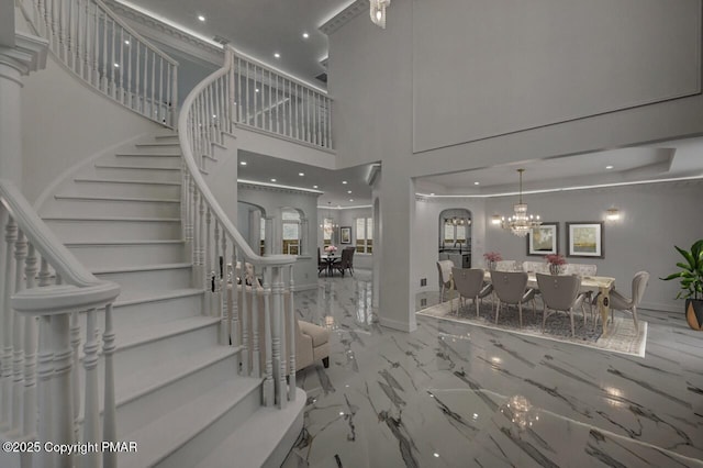 707 Kennedy Ct, East Stroudsburg, PA 18301 - stairs with marble tiled floors, recessed lighting, a chandelier, a high ceiling, and baseboards