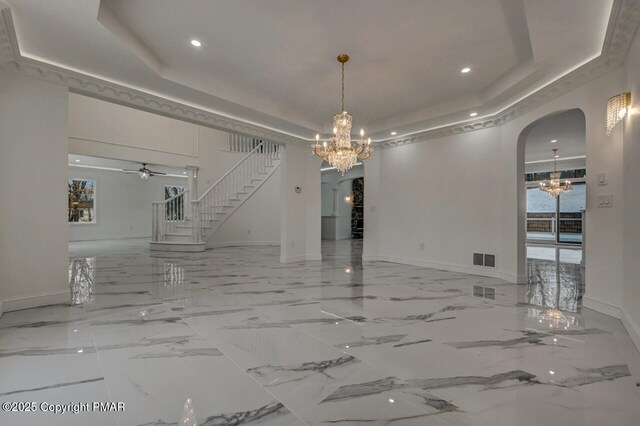 707 Kennedy Ct, East Stroudsburg, PA 18301 - unfurnished dining area featuring a chandelier, arched walkways, a raised ceiling, stairs, and recessed lighting