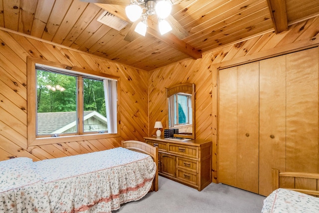 2173 Tuscarora Dr, Pocono Lake, PA 18347 - bedroom featuring light carpet, a wood ceiling with exposed beams, wooden walls, and a closet