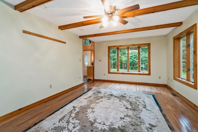 2173 Tuscarora Dr, Pocono Lake, PA 18347 - spare room with plenty of natural light, light wood-style floors, beam ceiling, and ceiling fan