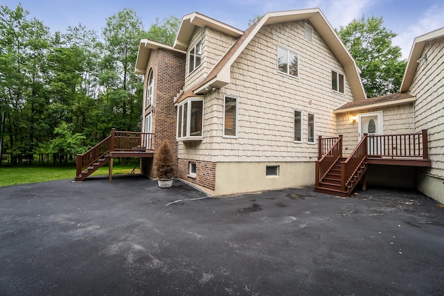 2173 Tuscarora Dr, Pocono Lake, PA 18347 - view of side of property featuring stairs, a gambrel roof, and a wooden deck
