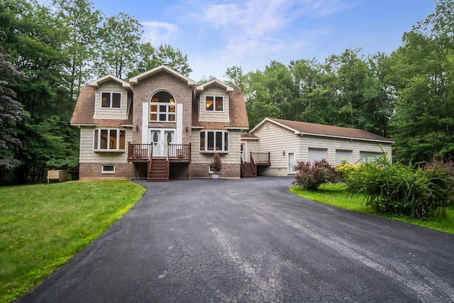2173 Tuscarora Dr, Pocono Lake, PA 18347 - view of front of house featuring a front yard, stairs, french doors, an outbuilding, and a deck
