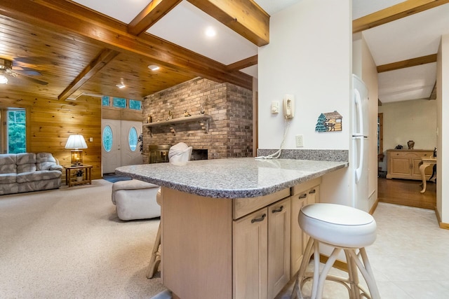 2173 Tuscarora Dr, Pocono Lake, PA 18347 - kitchen with a kitchen breakfast bar, beamed ceiling, wooden walls, a peninsula, and open floor plan