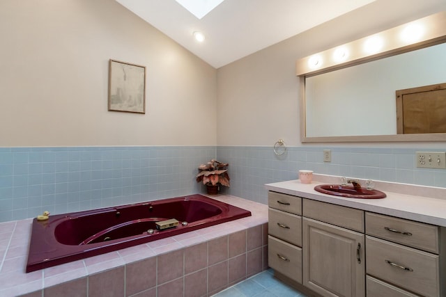 2173 Tuscarora Dr, Pocono Lake, PA 18347 - full bath with vanity, a tub with jets, vaulted ceiling, tile patterned floors, and a skylight