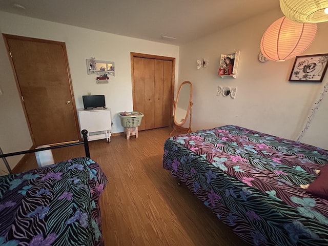 bedroom with a closet and wood finished floors