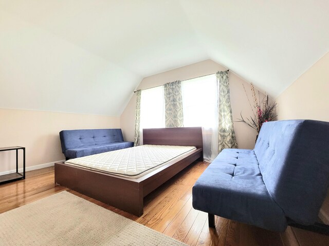 1025 Cricket Ln, Long Pond, PA 18334 - bedroom with wood finished floors and lofted ceiling