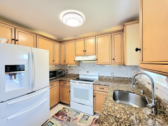 1025 Cricket Ln, Long Pond, PA 18334 - kitchen with white appliances, under cabinet range hood, tasteful backsplash, dark stone counters, and light tile patterned floors