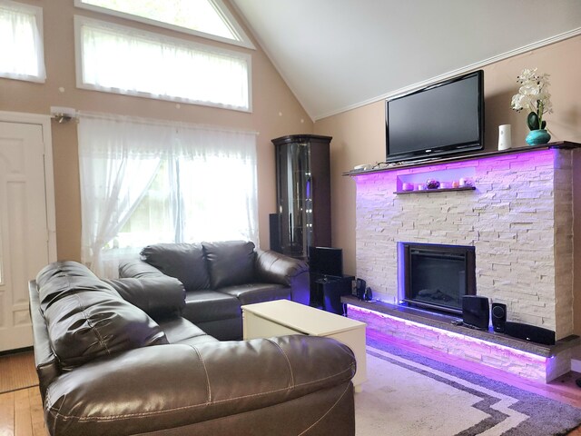 1025 Cricket Ln, Long Pond, PA 18334 - living area with wood finished floors, a stone fireplace, and high vaulted ceiling