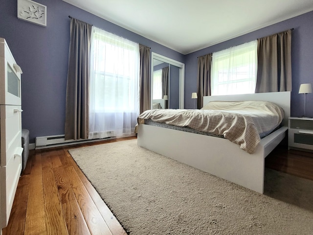 1025 Cricket Ln, Long Pond, PA 18334 - bedroom featuring baseboard heating, wood finished floors, and a closet