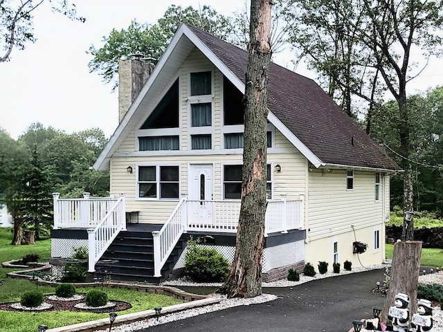 1025 Cricket Ln, Long Pond, PA 18334 - view of front facade with a chimney, a deck, and roof with shingles