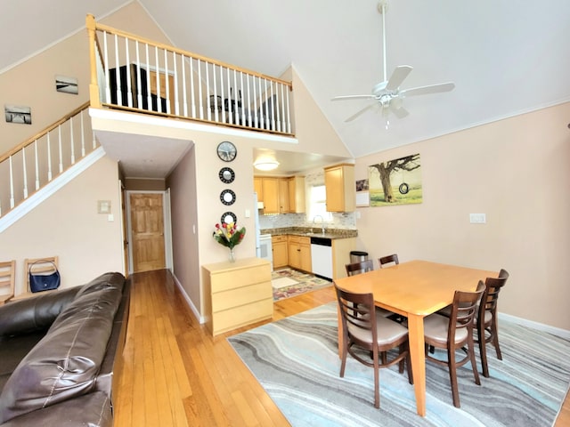 1025 Cricket Ln, Long Pond, PA 18334 - dining room with ceiling fan, light wood-style flooring, stairs, and high vaulted ceiling