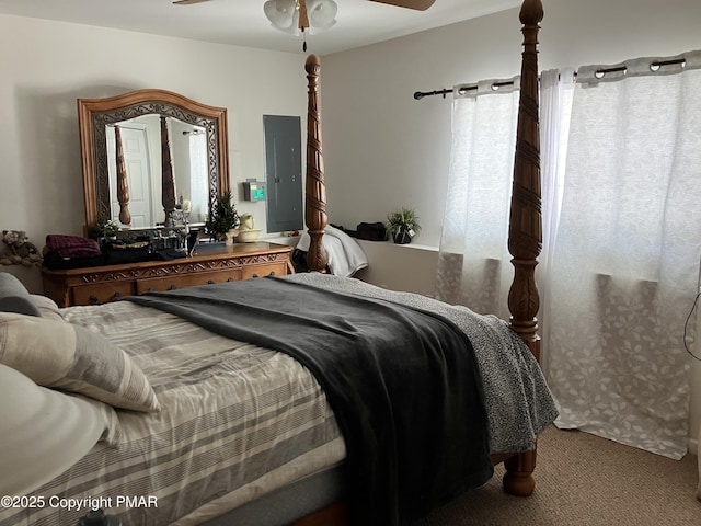 bedroom with ceiling fan, carpet, and electric panel