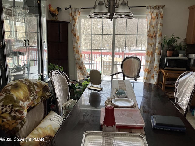 dining space with an inviting chandelier and a healthy amount of sunlight