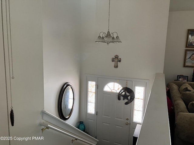 foyer with an inviting chandelier