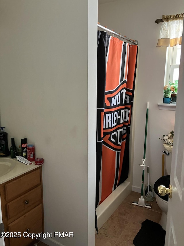 interior space featuring toilet, a shower with curtain, and vanity