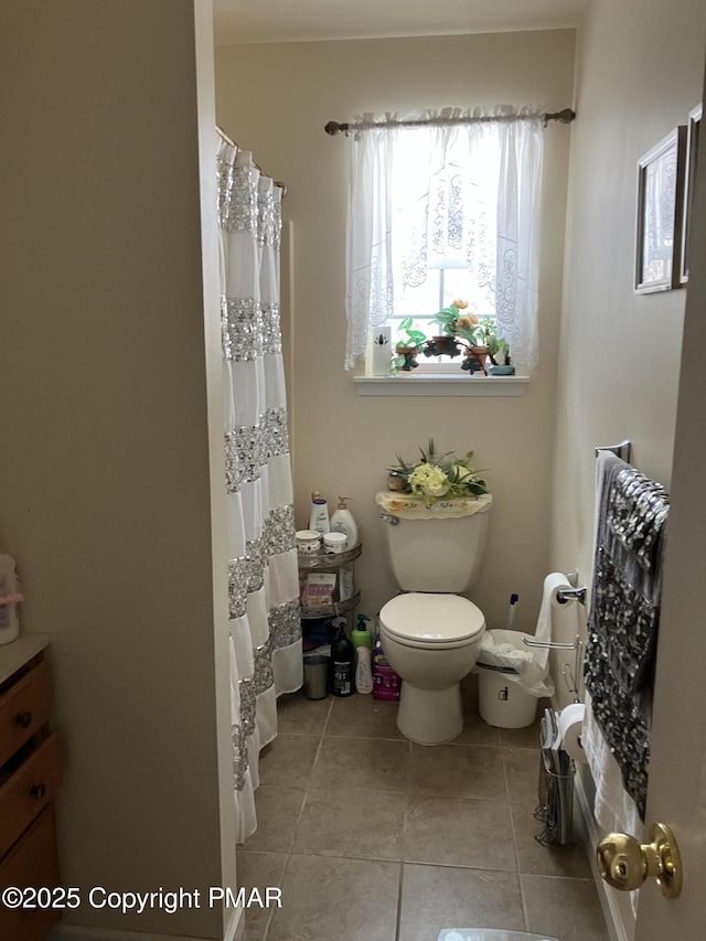 bathroom with toilet and tile patterned flooring