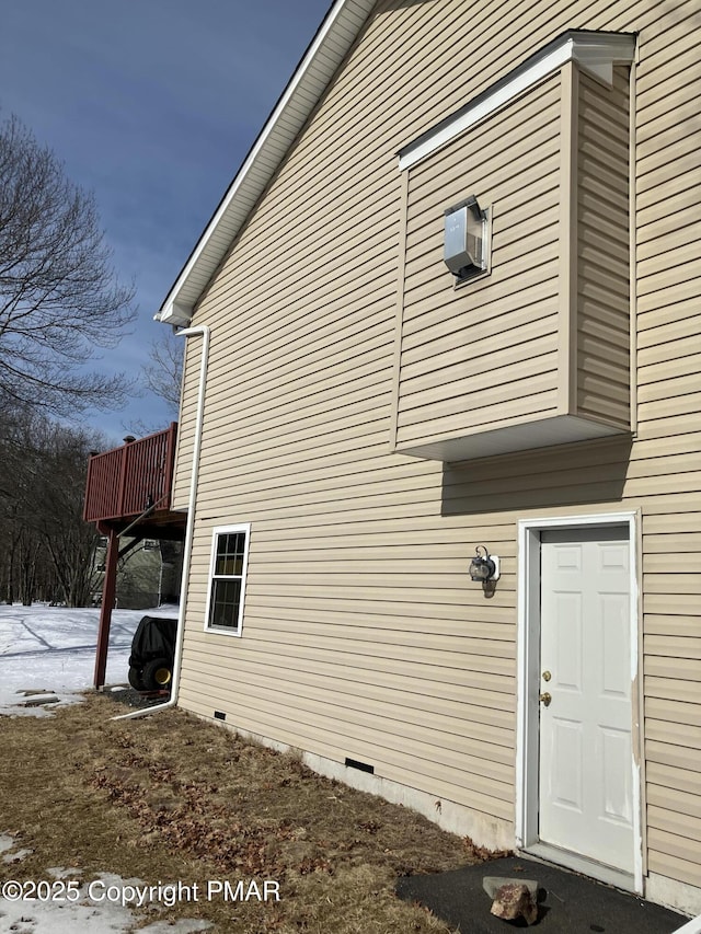 view of property exterior featuring crawl space and a wooden deck