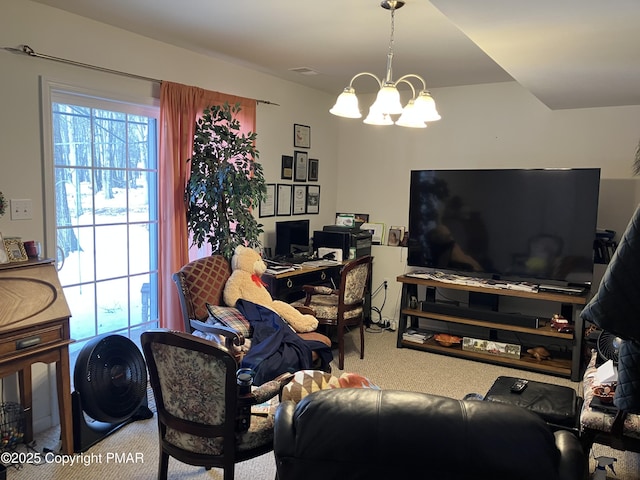 carpeted living area with a chandelier