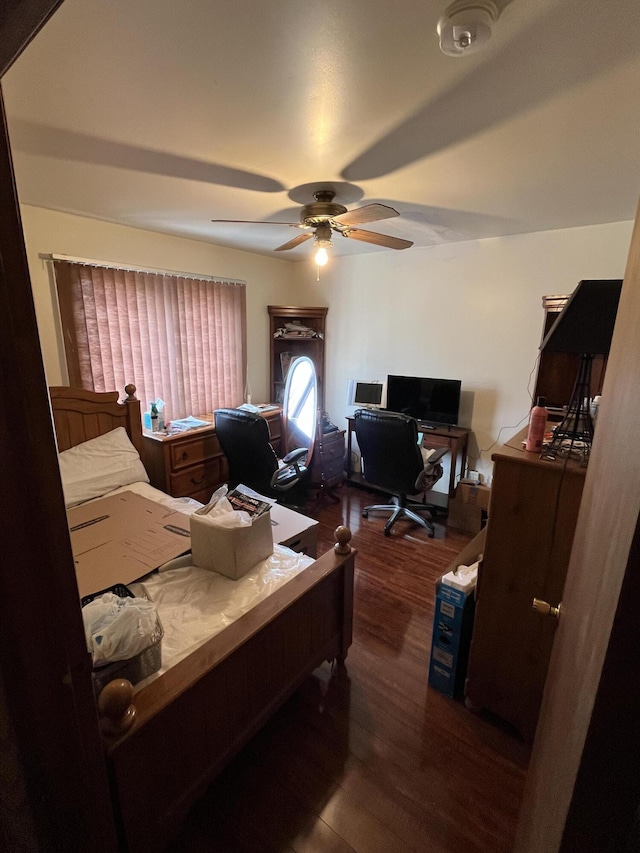 bedroom with ceiling fan and dark wood finished floors