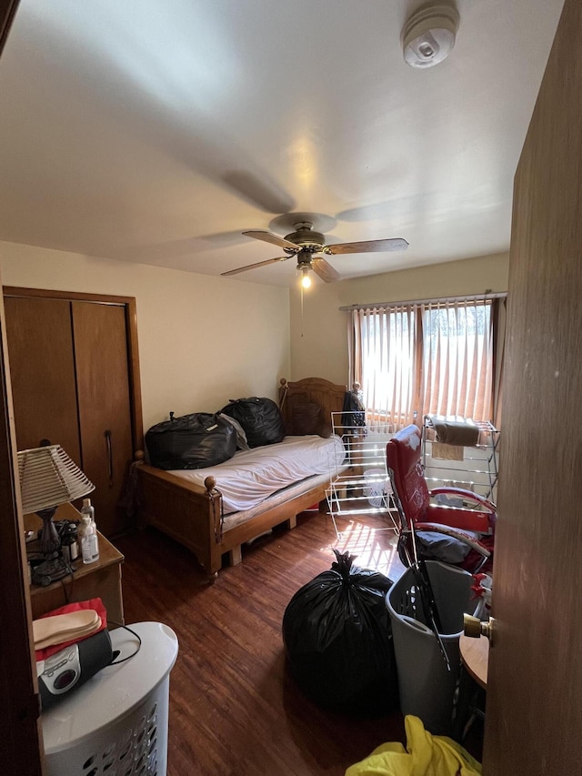 interior space with a ceiling fan and dark wood-style floors