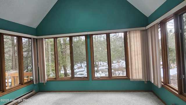 unfurnished sunroom with baseboard heating and lofted ceiling