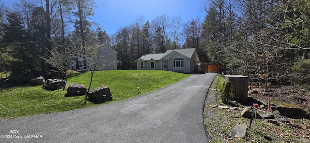 view of front of home with a front yard and driveway