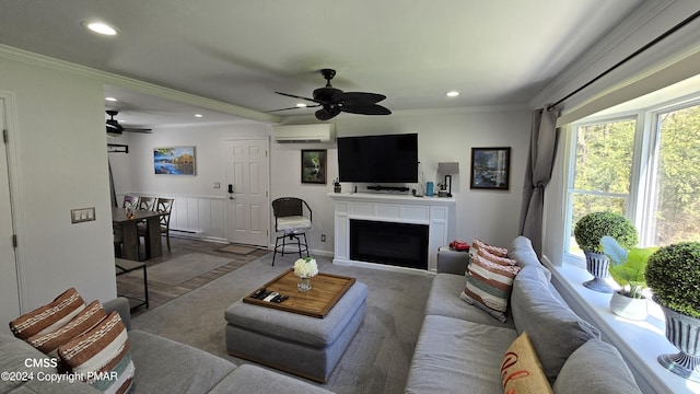 living area with ornamental molding, recessed lighting, a wall unit AC, and a fireplace