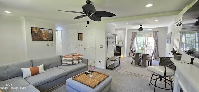 living area featuring recessed lighting, crown molding, baseboards, and ceiling fan