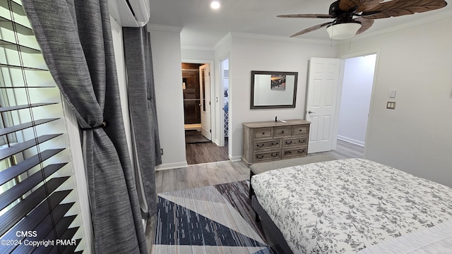 bedroom featuring ornamental molding, wood finished floors, and baseboards