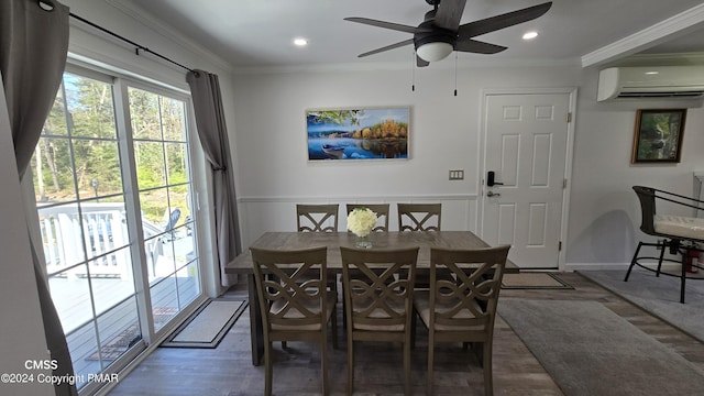 dining room featuring an AC wall unit, recessed lighting, wood finished floors, and crown molding