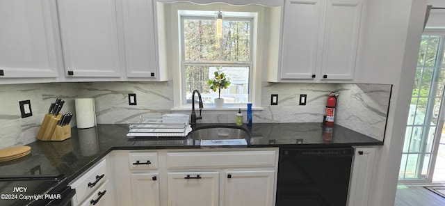 kitchen featuring dishwasher, decorative backsplash, a sink, and white cabinets